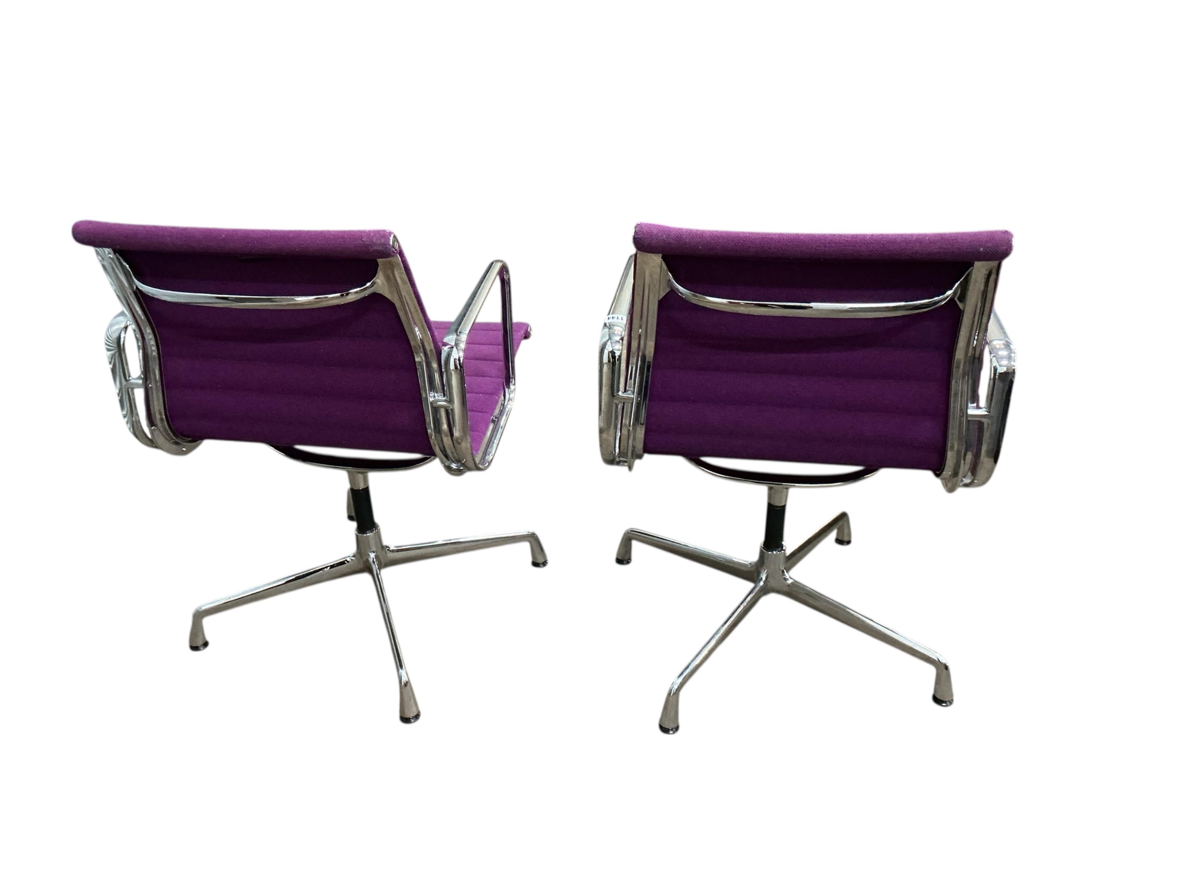 Charles Eames for Vitra, a pair of chrome swivel desk chairs on four prong bases, width 57cm, depth 50cm, height 82cm